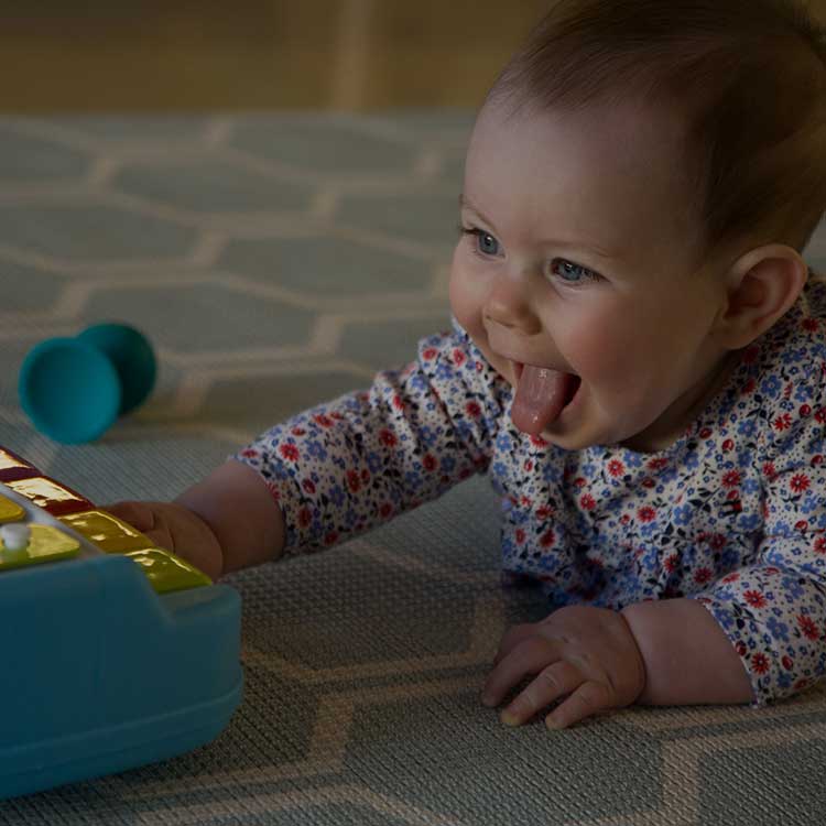 Baby playing with a xylophone