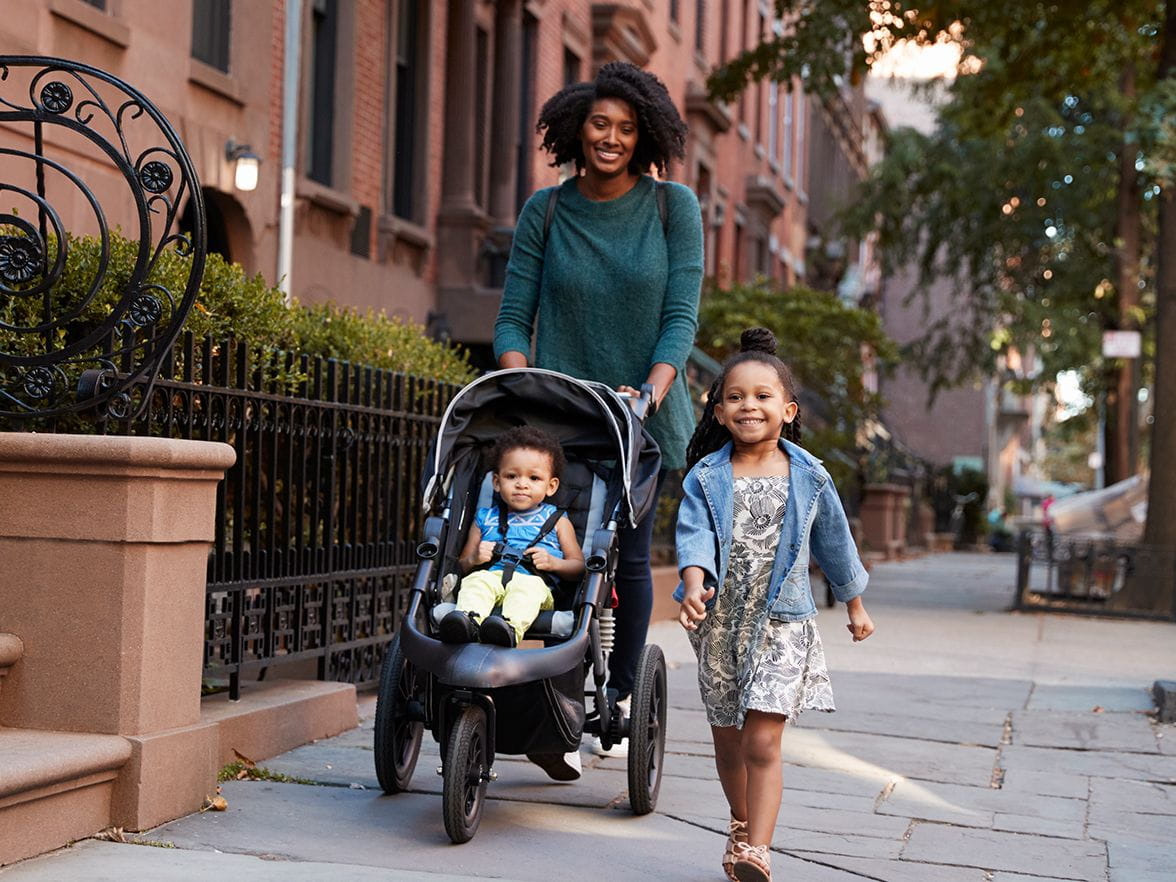 mother walking her children in the city