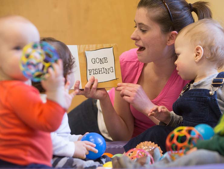 Infant teacher playing with babies at Bright Horizons