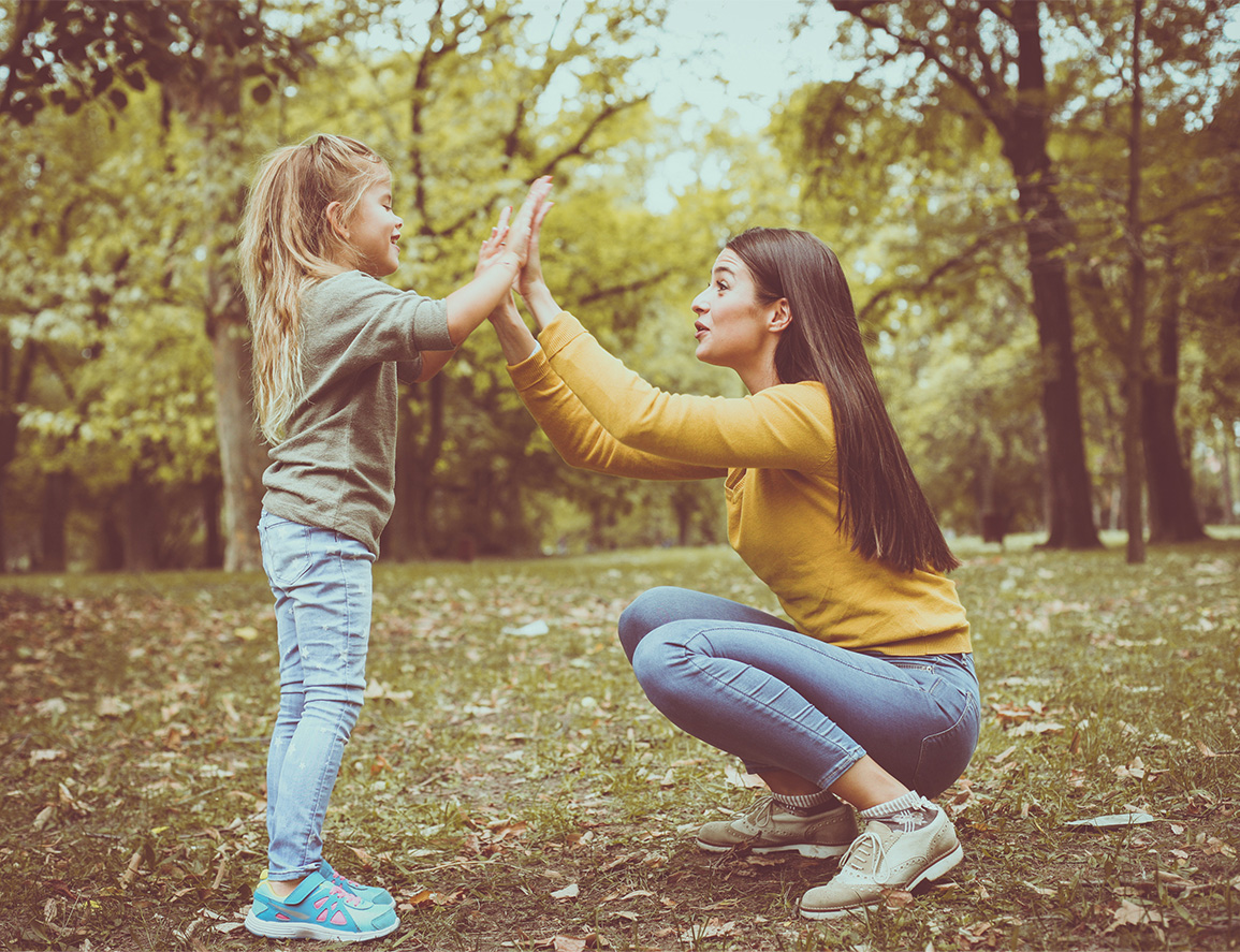 A mom and daughter playing in the park.