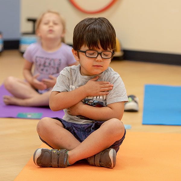 boy sitting crossed legged