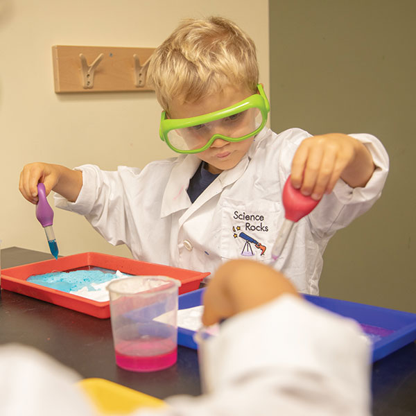 Preschool curriculum activity of boy working on STEM project at Bright Horizons