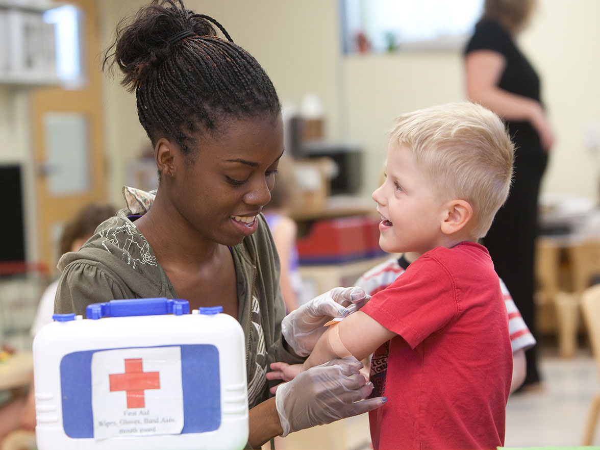 Teacher treating a child at a center