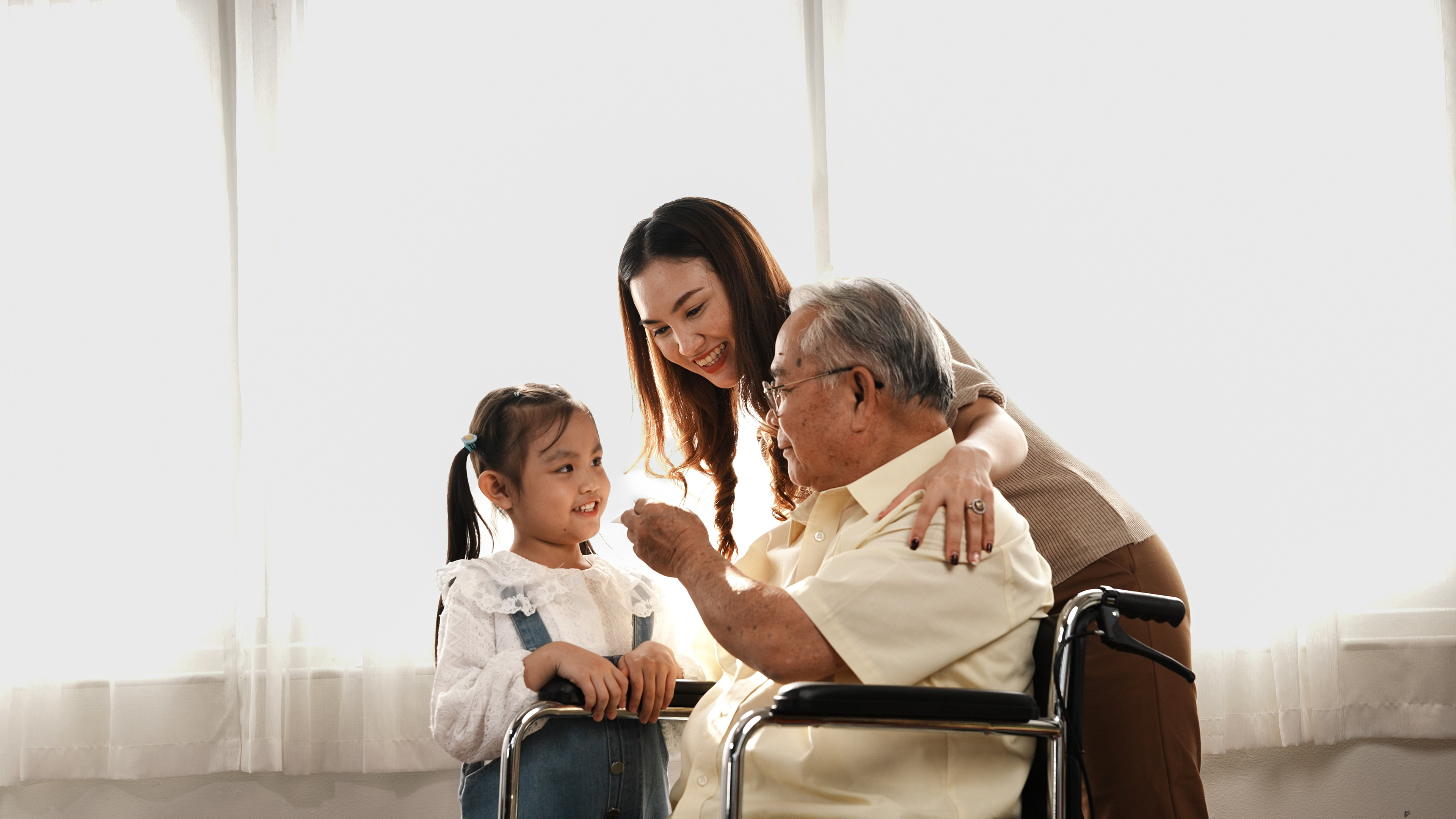 A mother and daughter spending time with their elderly loved one