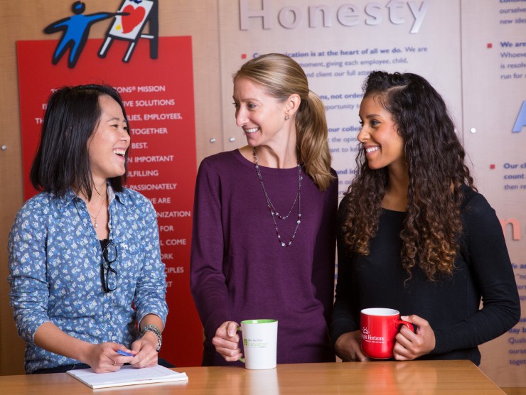 three employees smiling 