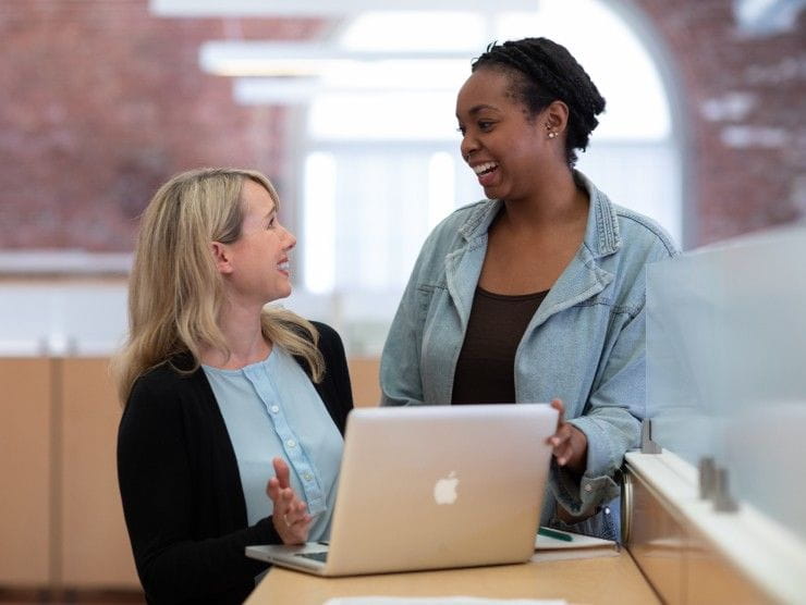 women co-workers talking 