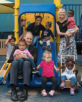 Bright Horizons Leadership smiling with children in playground