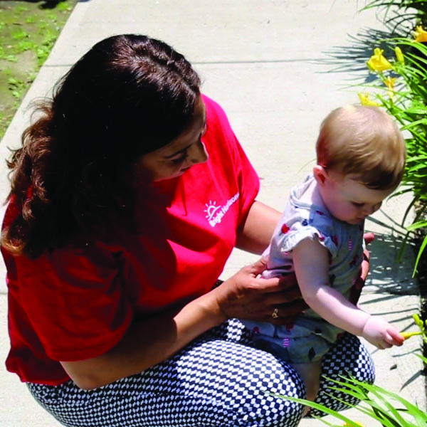 Teacher with infant outside