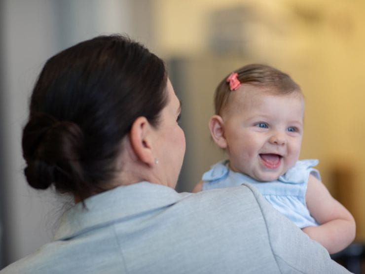 infant girl being enjoying her first time in back-up care