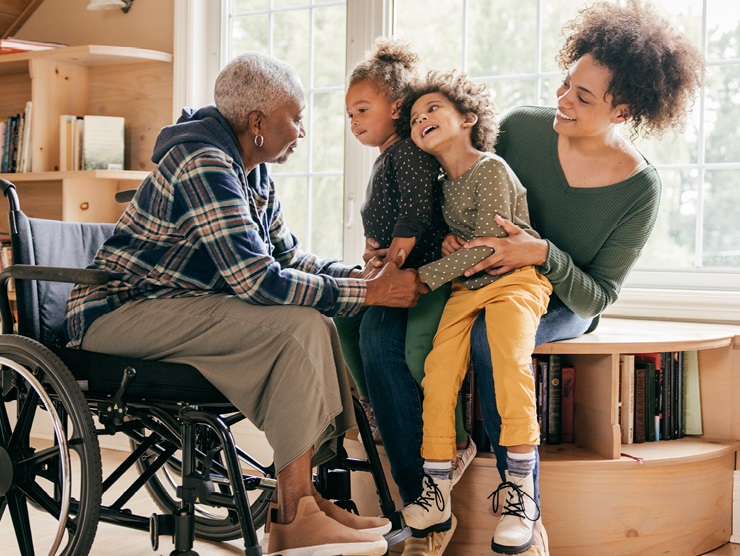 Two children playing with their parent and grandparent