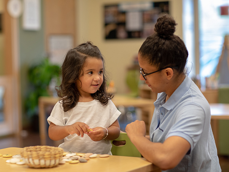 girl learning from teacher