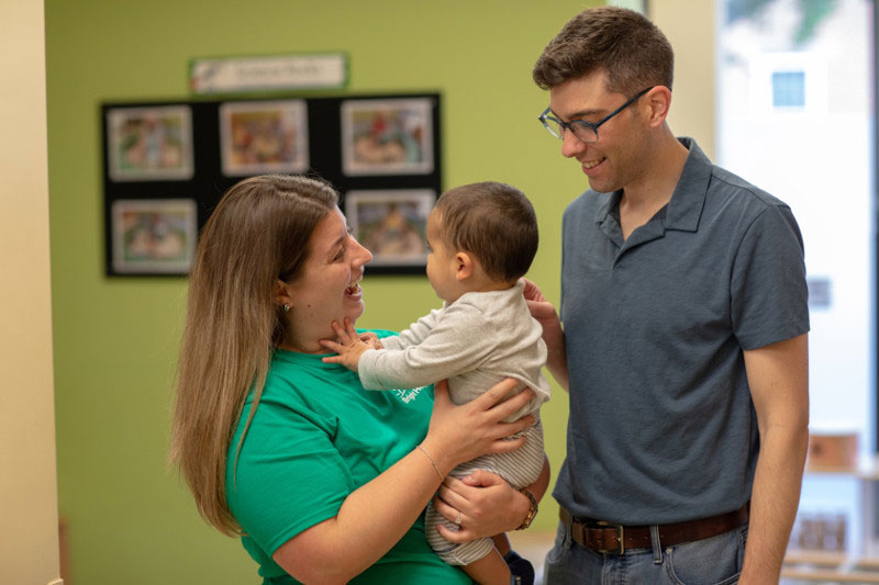 Dad dropping his baby off at a child care center