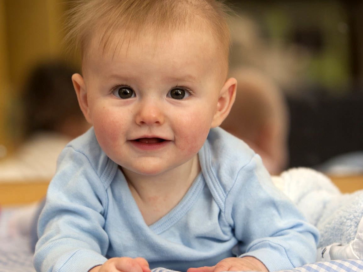 An infant laying on it's stomach