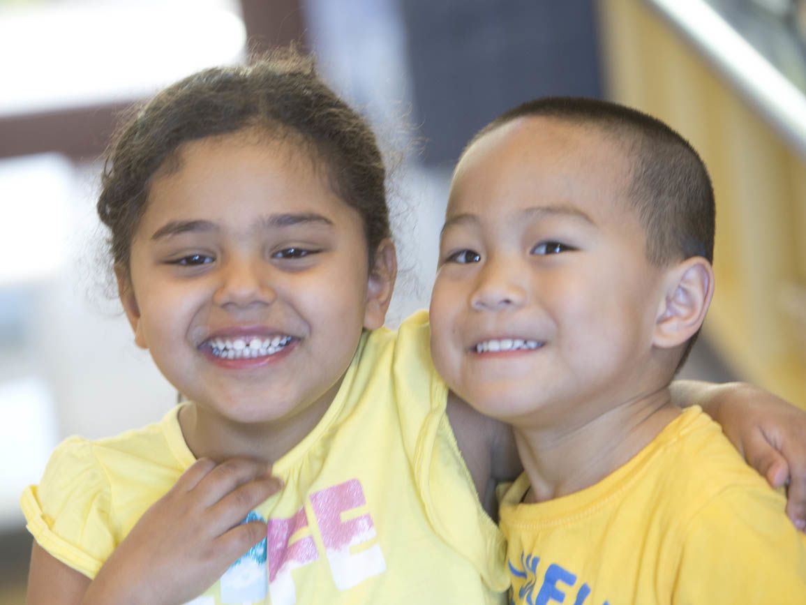 Two children smiling together