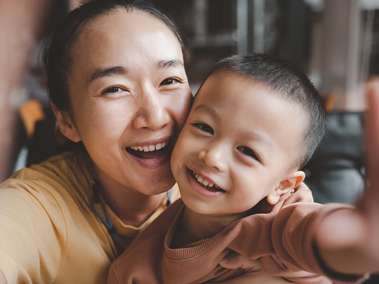 Mother and son smiling while taking a picture together