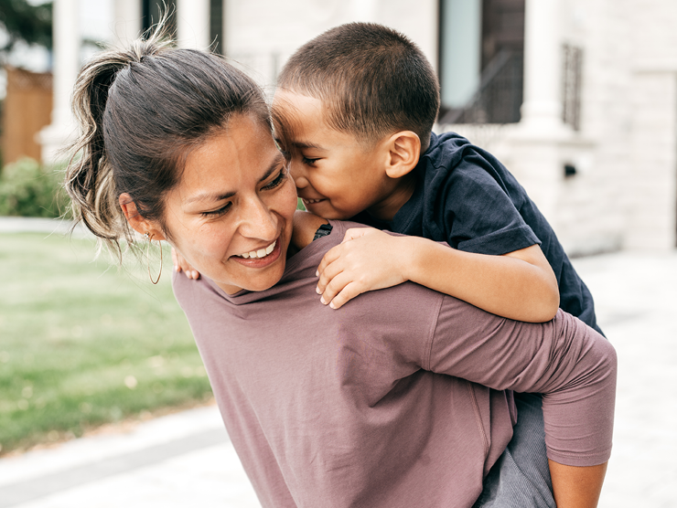 Woman carrying child on back