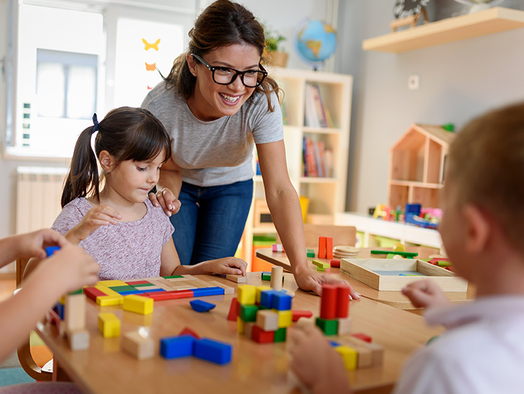 Teacher with two students in a child care center