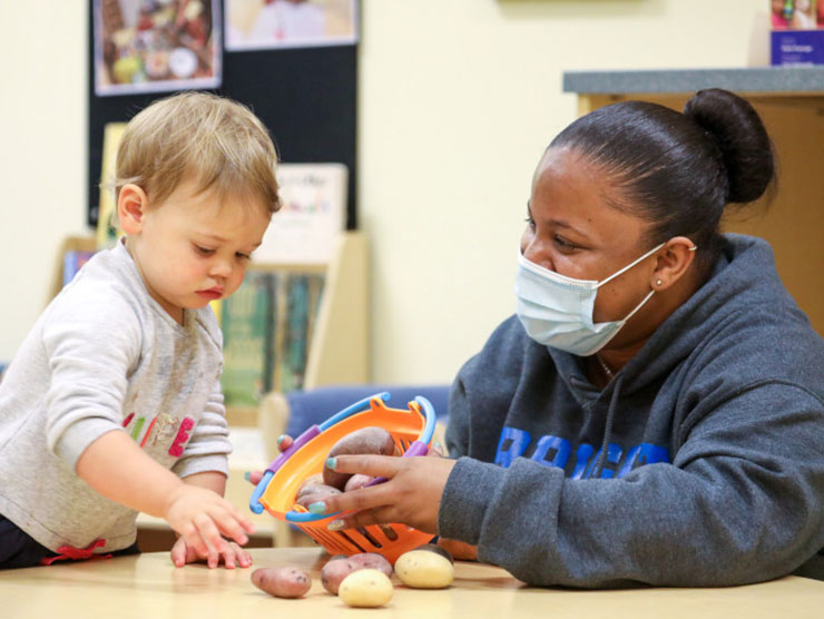 Bright Horizons Daycare Teacher in mask with young boy