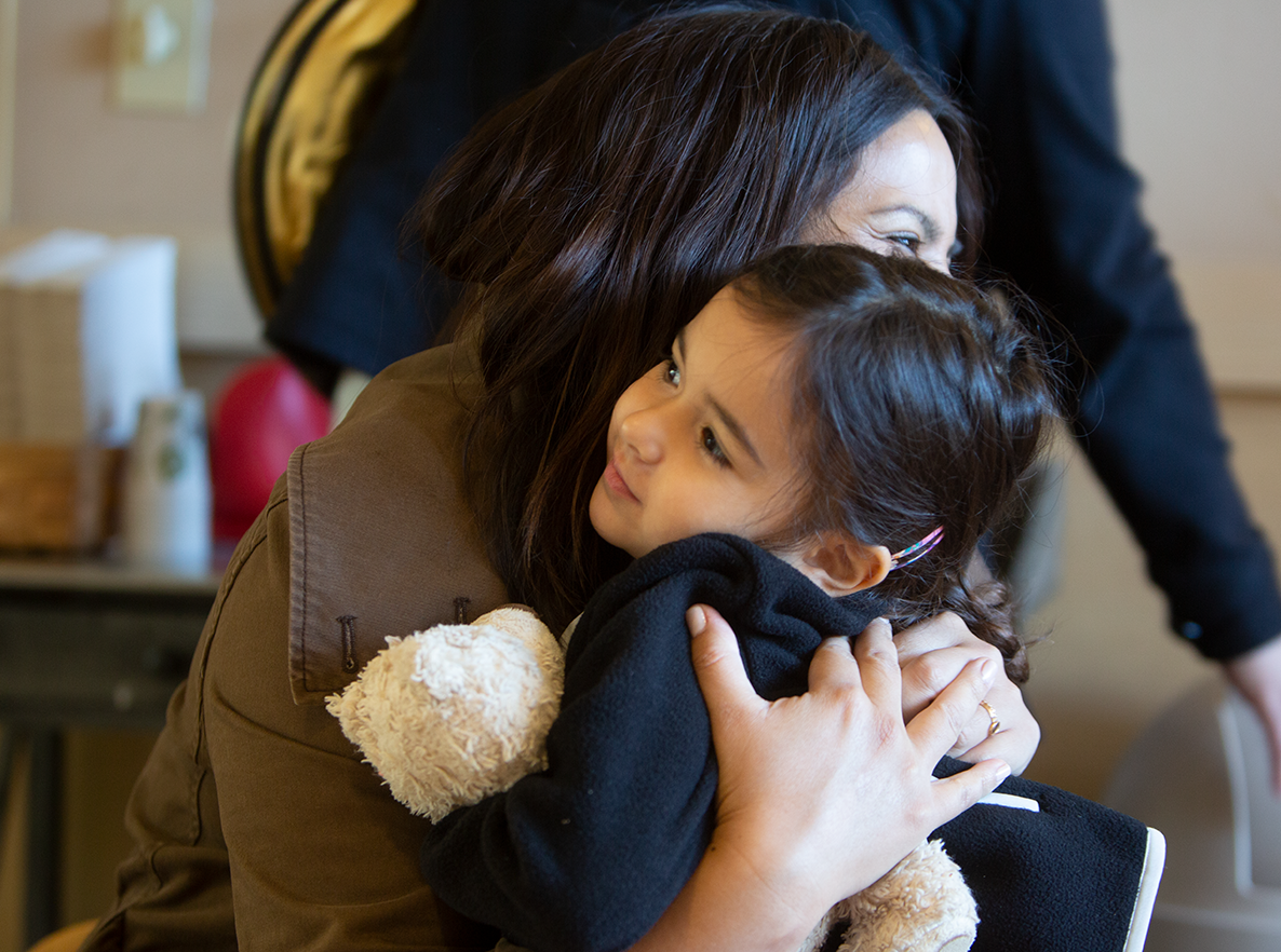 mother and toddler daughter hugging