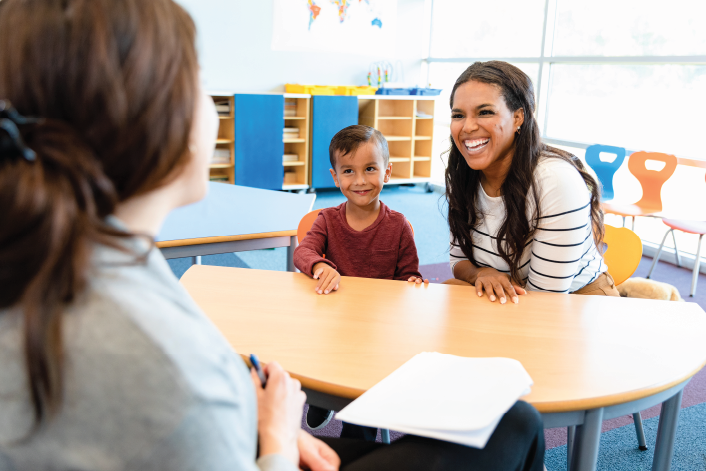 Mother and son meeting with their child care teacher