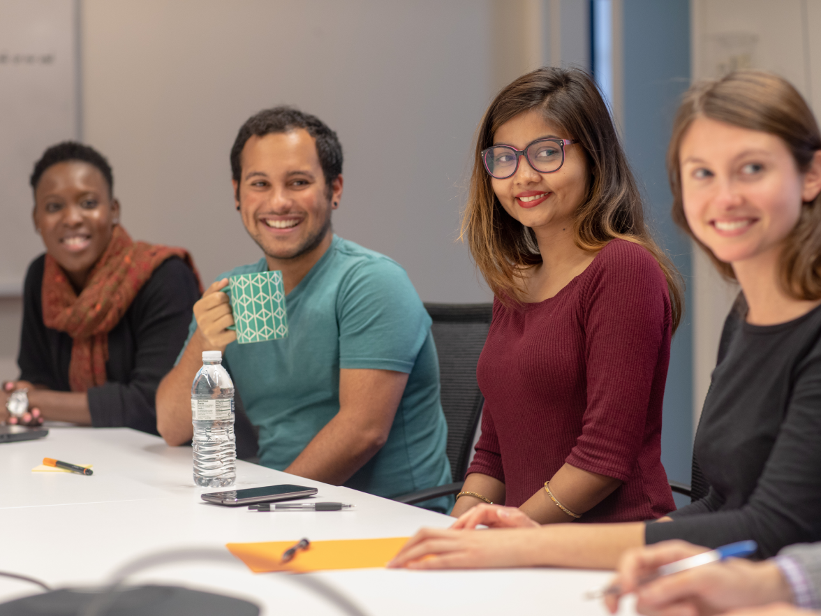 Employees smiling in meeting room