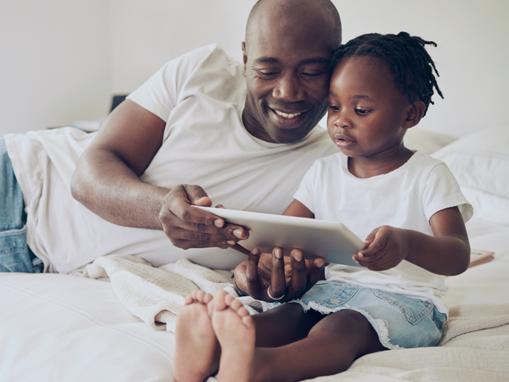 man with child daughter on bed